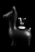 Three-quarter view of the matte black Art of Smoke Alpaca Bubbler shaped like a small standing alpaca with a clear glass bowl inset on its back