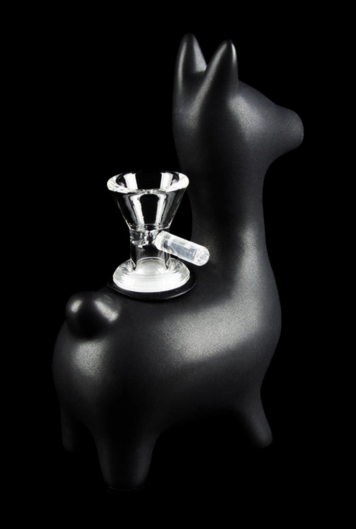 Three-quarter view of the matte black Art of Smoke Alpaca Bubbler shaped like a small llama with a clear glass bowl mounted on its back.