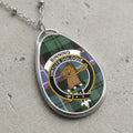 Binning clan Scottish tartan necklace with clan crest on tartan background