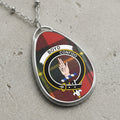 Boyd crest pendant necklace with Confido over a tartan background