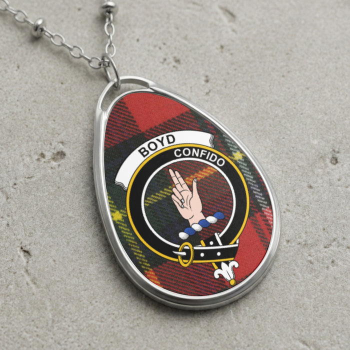 Boyd crest pendant necklace with Confido over a tartan background