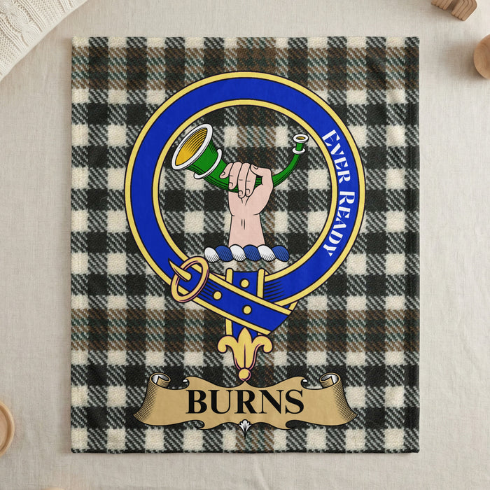 Burns clan crest on tartan throw blanket — draped display