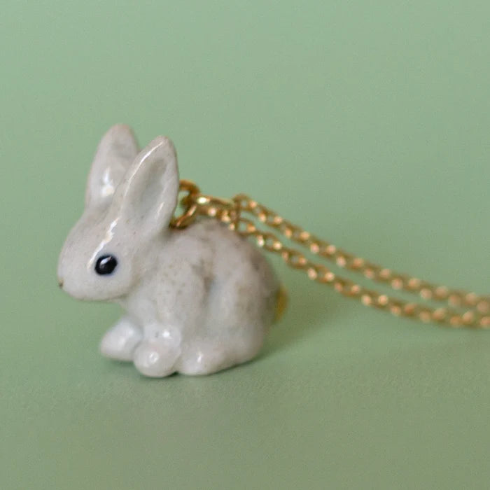Camp Hollow Porcelain Goldentail Rabbit Necklace on green background.