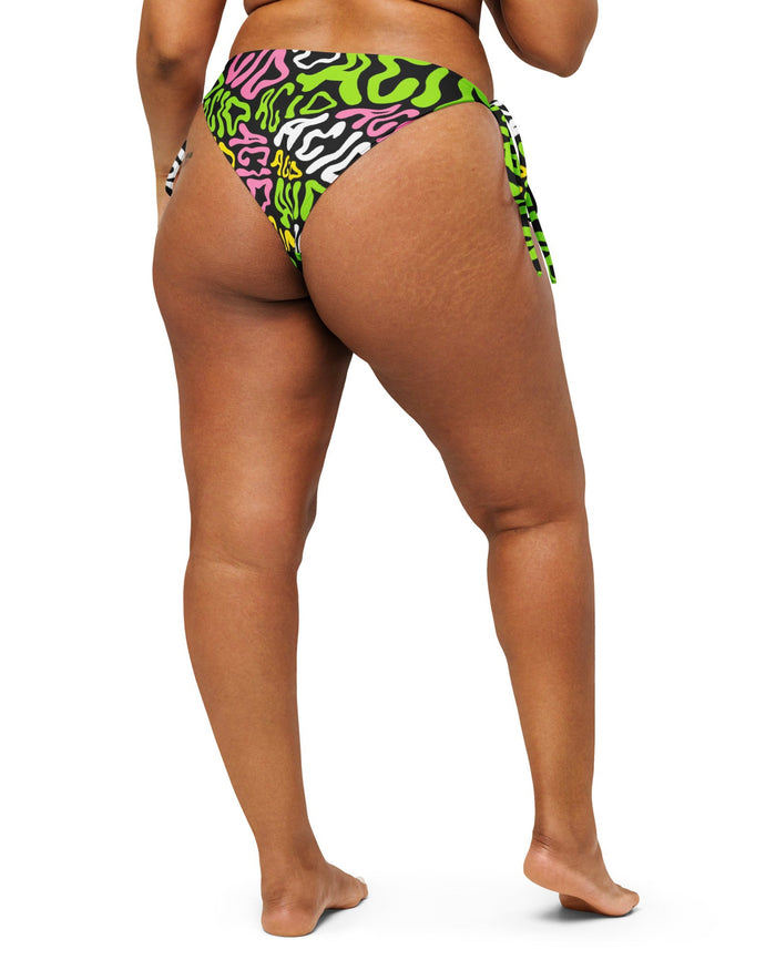 The back of the Candy Acid Recycled String Bottoms by One Stop Rave  on a model.