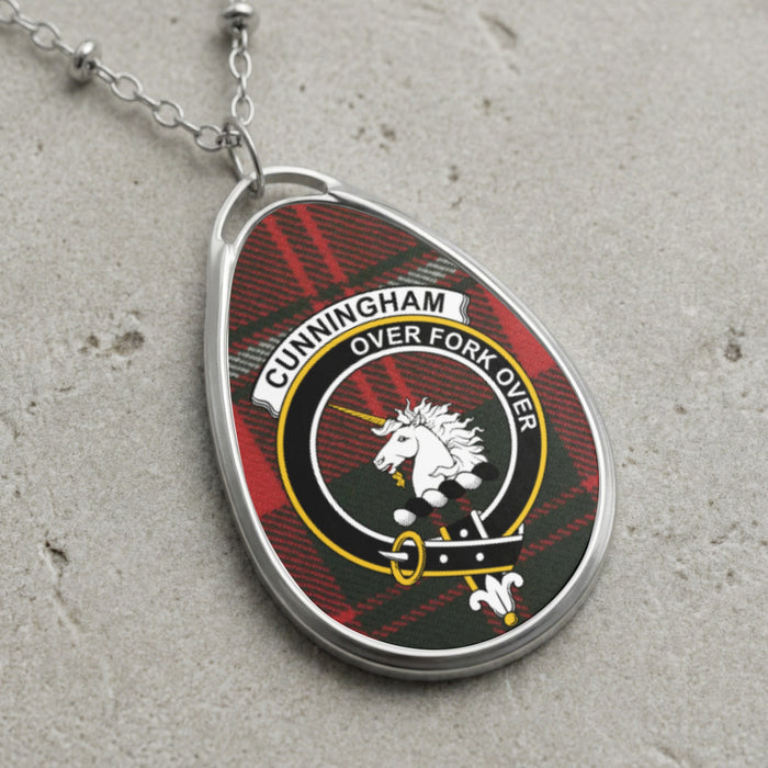 Cunningham clan Scottish tartan necklace with clan crest and Over Fork Over motto on tartan background
