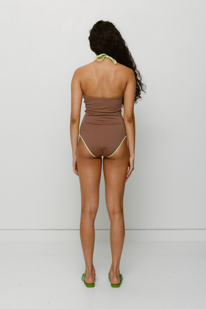 Hand-crocheted halter neck one-piece swimsuit with floral patterns and contrast piping by The Wolf Gang, limited edition design.