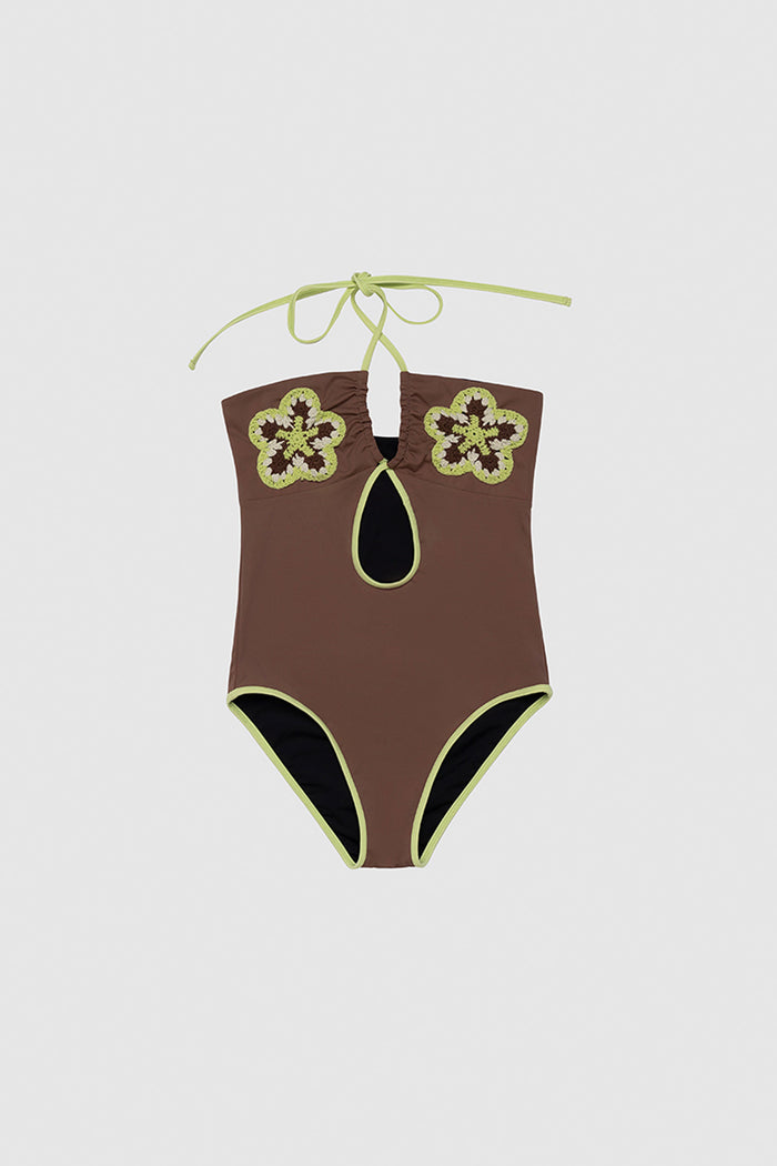Hand-crocheted halter neck one-piece swimsuit with floral patterns and contrast piping by The Wolf Gang, limited edition design.