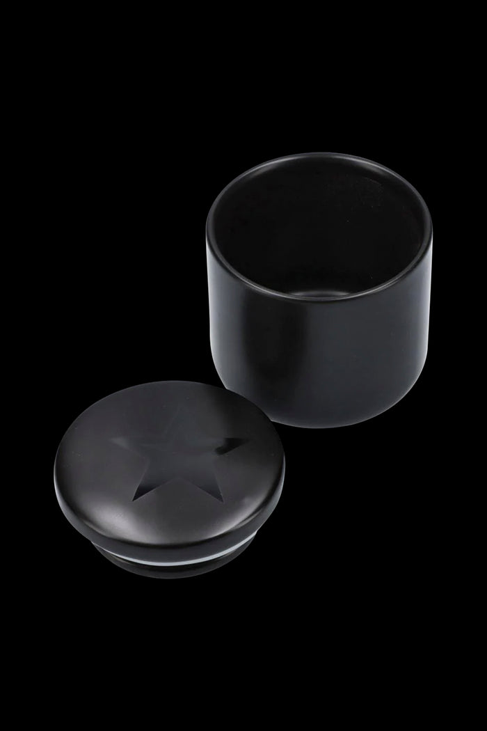 Black cannabis storage jar with lid separated.