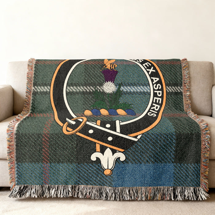Ferguson clan crest with bee on thistle woven into tartan throw