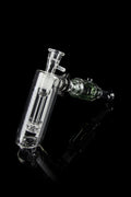 Clear glass bubbler and oil rig with intricate design, isolated on black.