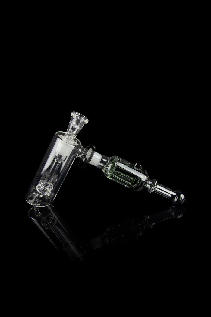 Glass rig with bubbler and connection for dabbing, isolated on black.