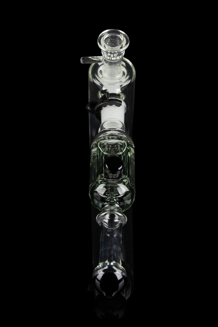 Clear glass bubbler water pipe against a black background.