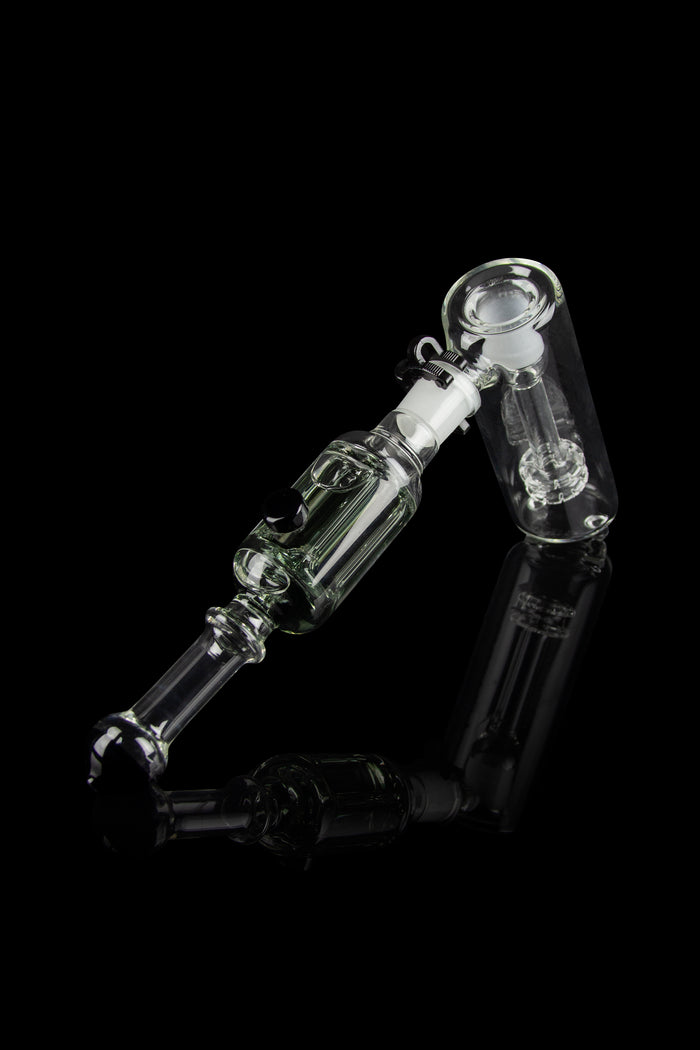 Clear glass oil rig with complex bubbler design, isolated on black.