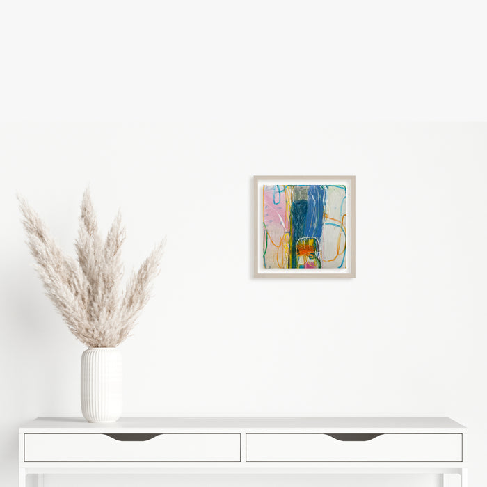 The artwork 'LS no. 14' by Janice La Motta features vibrant abstract expressionism with bold strokes of deep blue and soft pink hues, complemented by earthy yellow tones. The oil pastel composition on Yupo paper creates dynamic movement through gestural marks and layered textures, showcasing spontaneous brushwork within a 9x9 inch square format. By Janice La Motta.