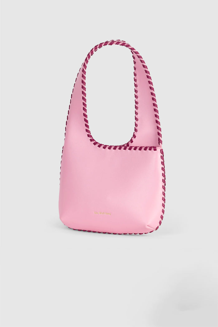 Women’s Candy Pink Mara Shoulder Bag in 100 percent leather with twisted strap contrast binding and magnetic snap closure for everyday wear.