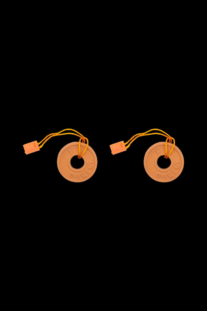 Two orange cannabis rosin press plates with looped yellow cords and orange end caps on a black background.
