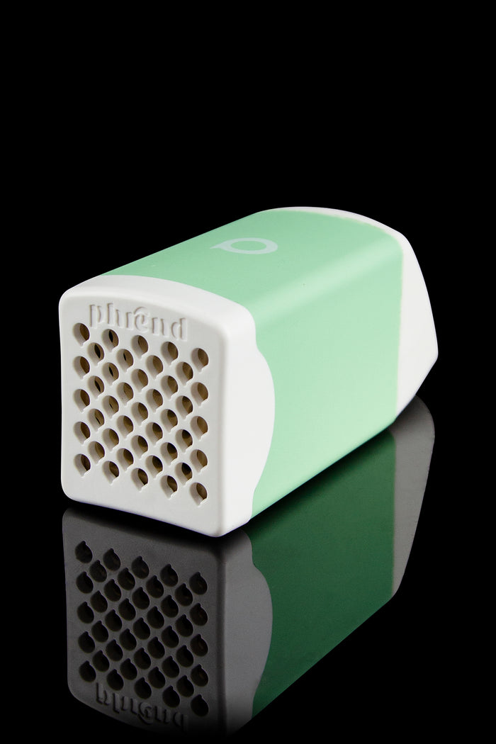 Green cannabis vaporizer, branded “Puffit,” with a perforated side and reflective surface.