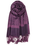 Purple scarf with intricate patterns and fringes on a white background