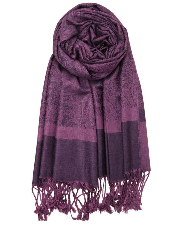 Purple scarf with intricate patterns and fringes on a white background