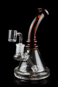 A clear glass rig with a colored mouthpiece and a quartz banger, isolated on a black background.