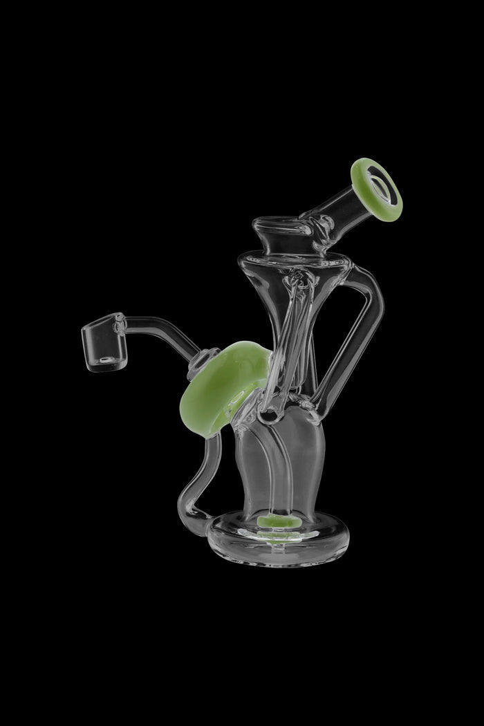 Angled close-up of the clear glass Power Button Recycler Rig with milky green accent rings against a black background