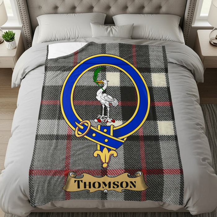 Thomson throw with crest and name on a bed