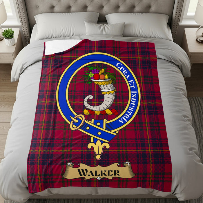 Walker clan crest with Cura et Industria motto on red tartan throw